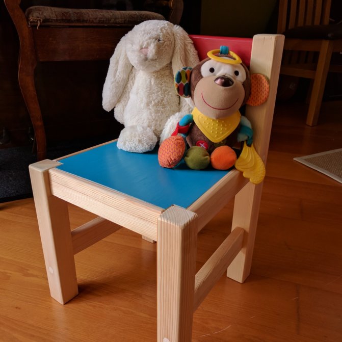 Kid's colourful chair with soft cuddly toys on it