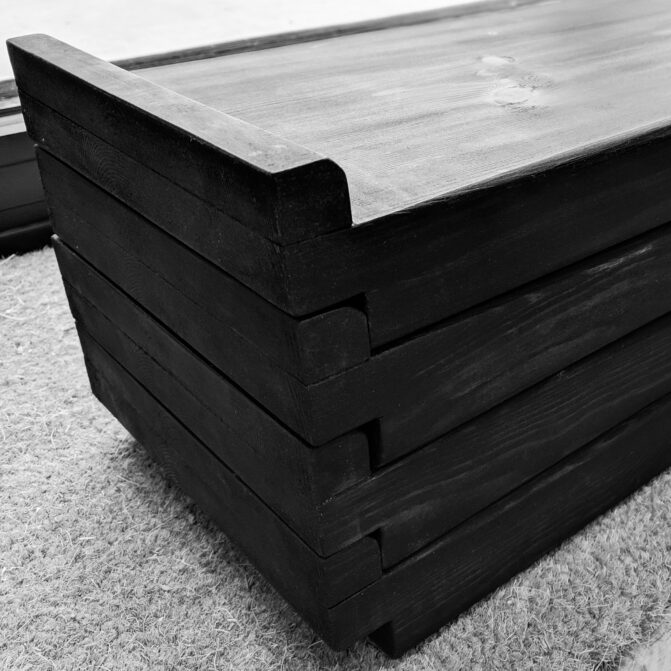 Black and white image of stack of four deadlift blocks with ebony stain