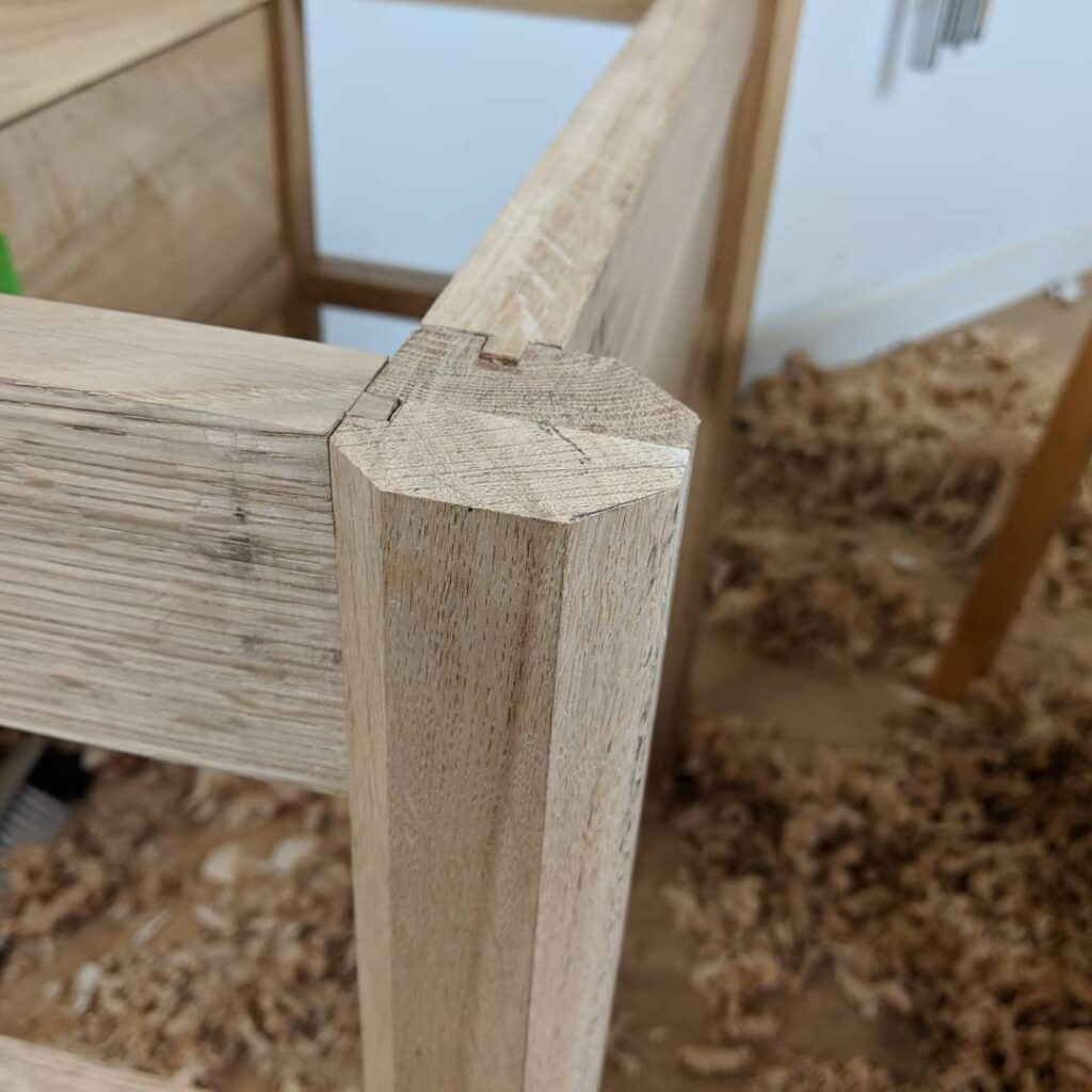 Mortise and tenon joinery for the legs on the central table frame