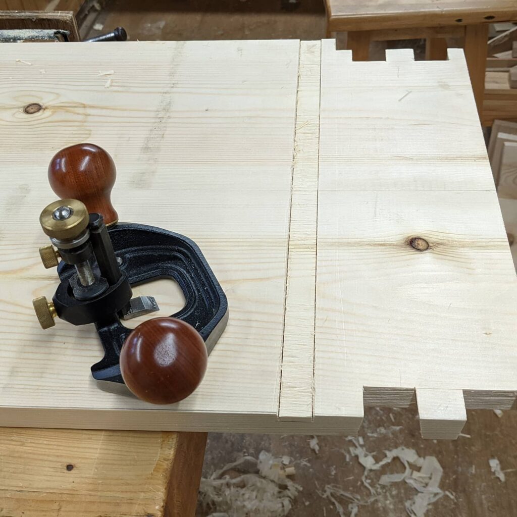 Routing out the housing dados for the horizontal drawer rail frames